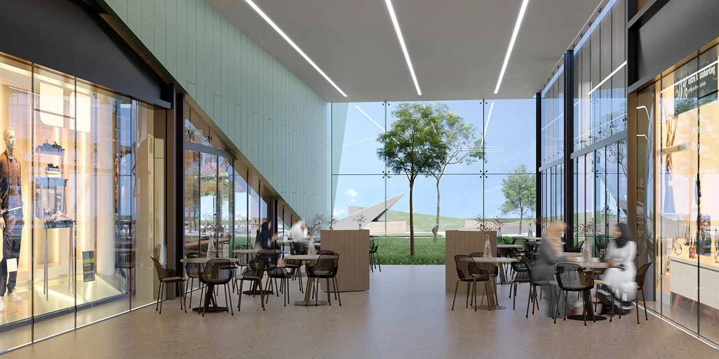 Modern shopping mall interior with seating area, large glass windows showing trees and outdoor scenery, mannequins display clothing, and a bright open design with ceiling LED light strips.