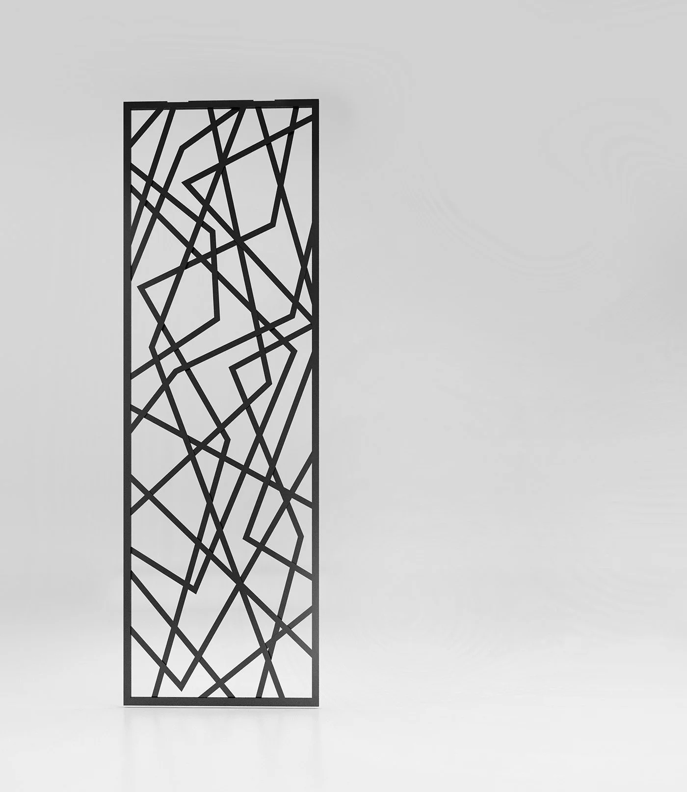 A tall black metal geometric decorative room divider with abstract interconnected lines, standing in a white room.