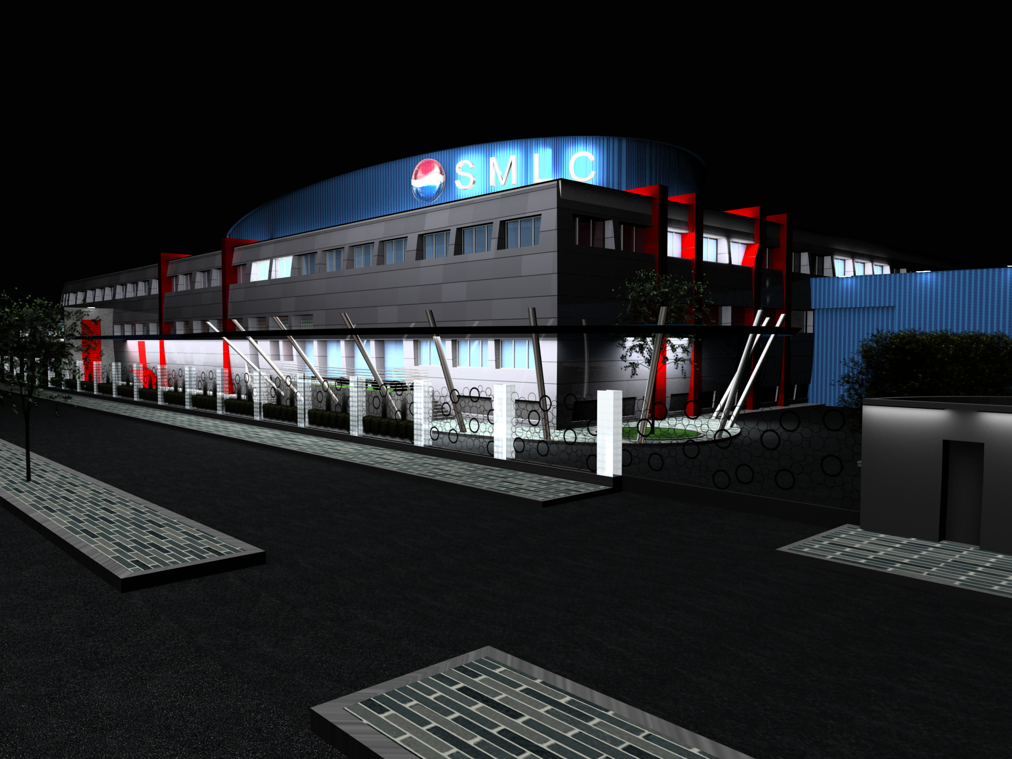 Night view of a modern building with blue signage and red accents, surrounded by a fenced area and a paved walkway.