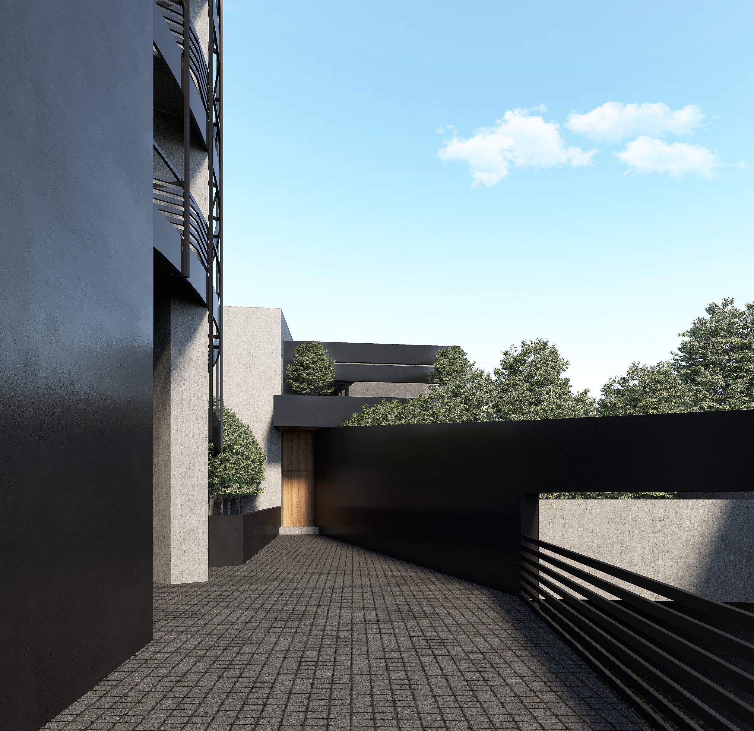 Modern outdoor walkway with concrete walls, black metal railings, and trees in the background under a blue sky with clouds.
