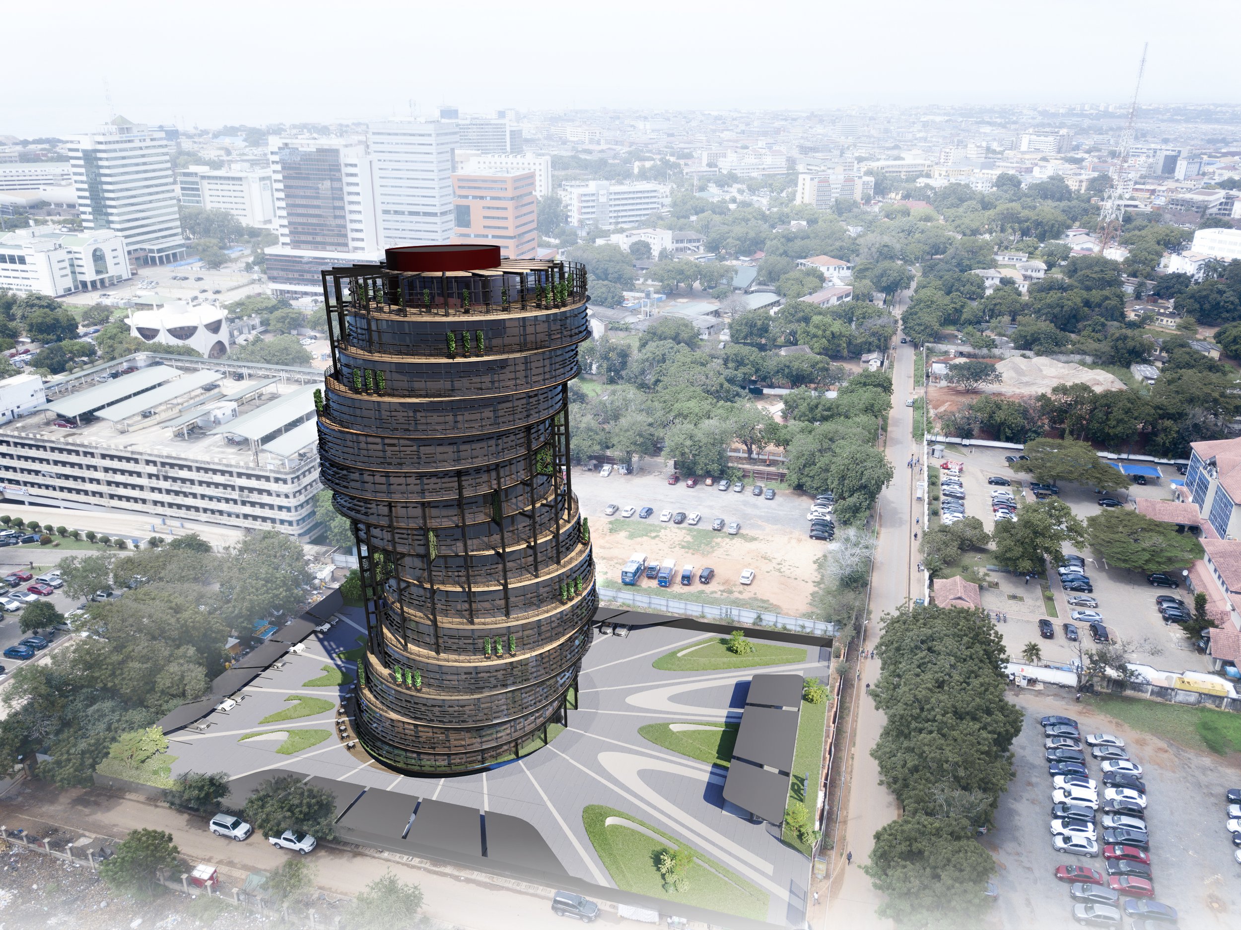 An aerial view of a city with a tall, modern, multi-story building with rounded balconies and green plants on each level in the foreground. The cityscape includes various mid-sized buildings, trees, parking lots, and roads under a hazy sky.