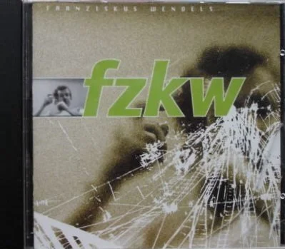 Plattencover mit dem Titel "fzw" und einem Porträt einer Person im Hintergrund, sowie zerbrochene Glasscherben im Vordergrund.