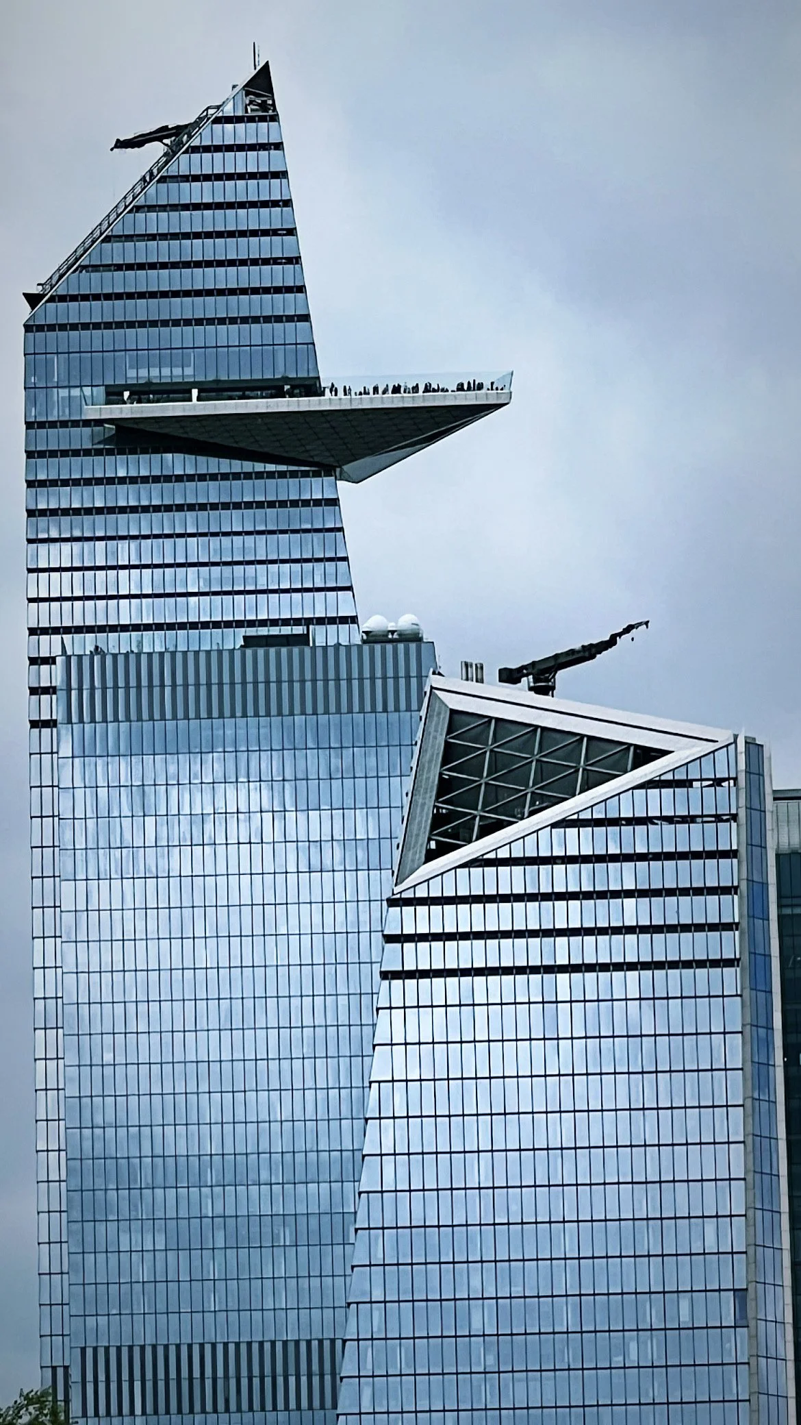Tall glass skyscrapers with modern architectural design and angular shapes.