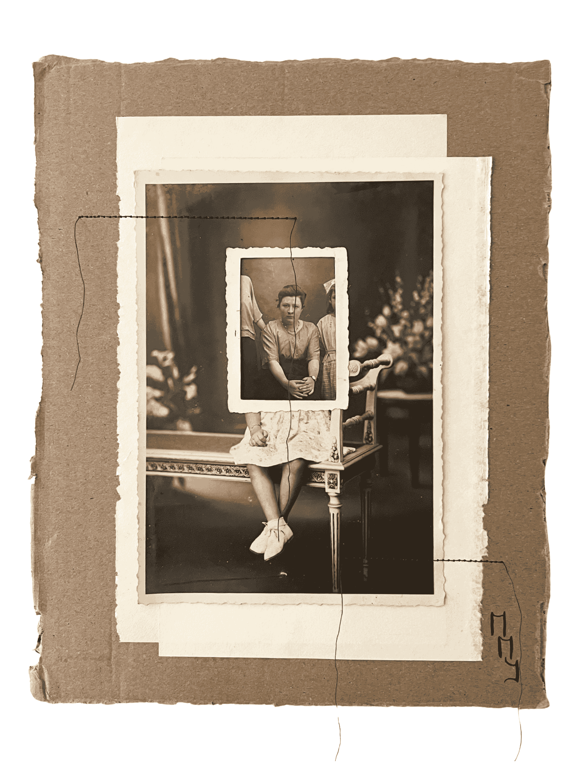 An old sepia-toned photograph showing a woman sitting on a bench with a framed picture of a woman in front of her, creating a recursive visual effect.