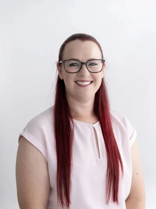 Psychologist Jessica Parker, psychologist for adolescents and adults on the Gold Coast, smiling, wearing glasses in a professional headshot