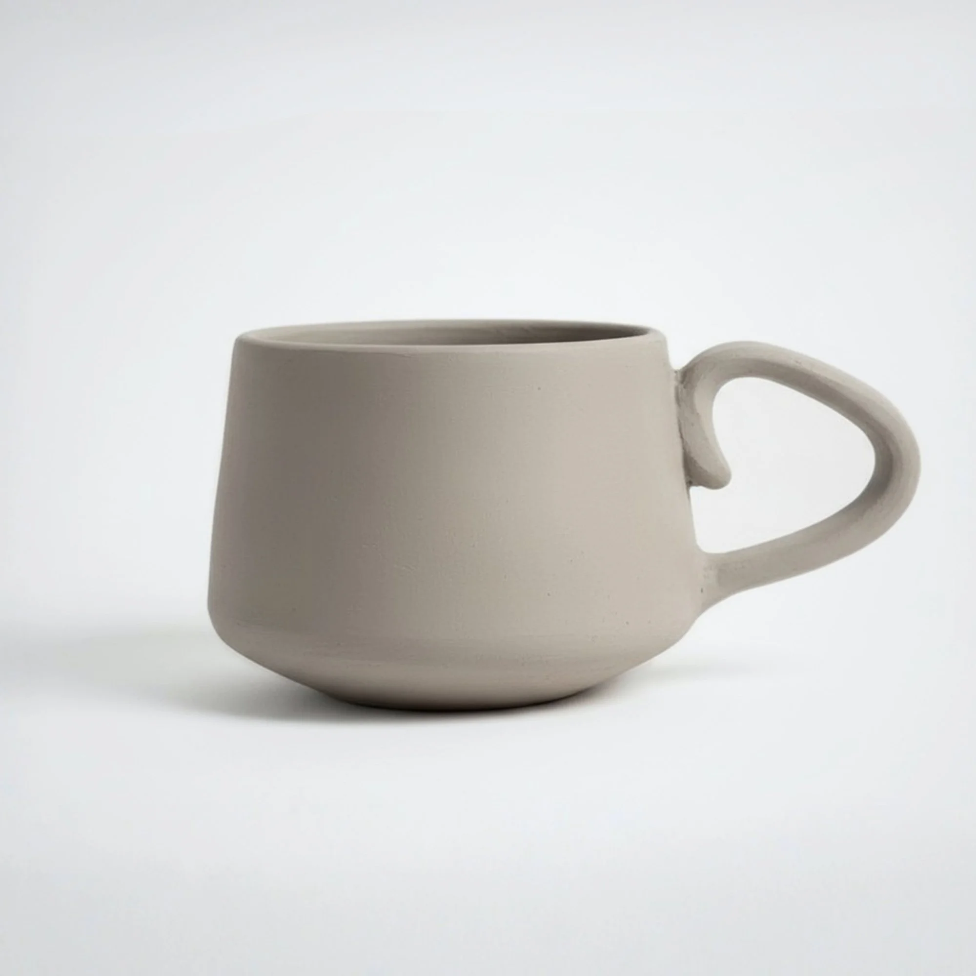 Minimalist handmade pottery mug with handle, clean design inspired by pottery template and ceramic template for slab pottery, perfect for beginner ceramics projects.