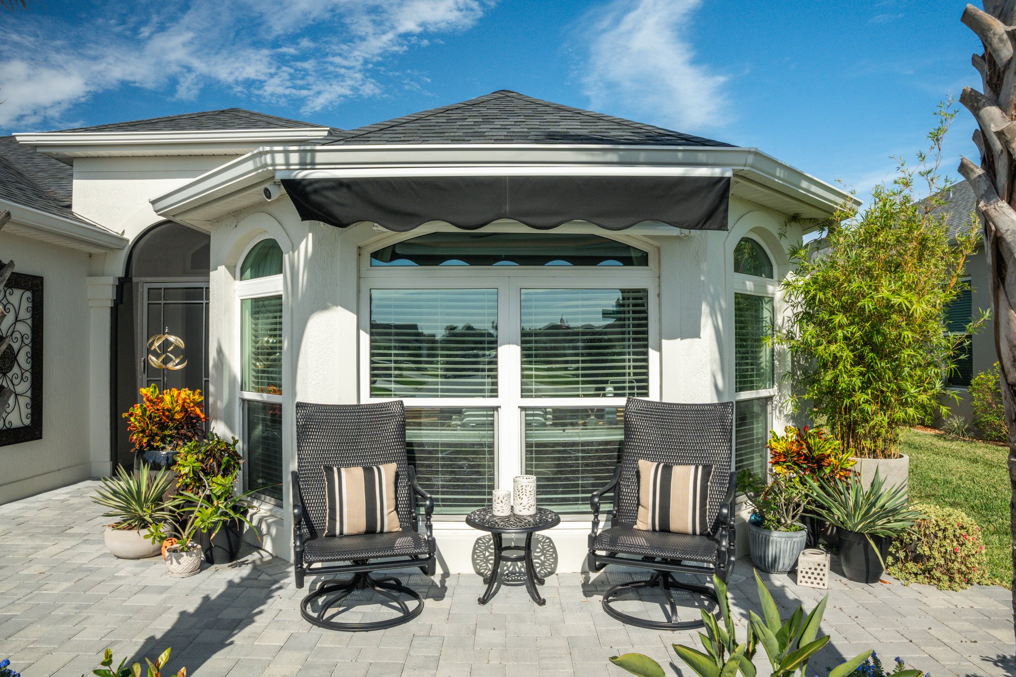 Modern motorized retractable awning on a deck creating comfortable outdoor living space