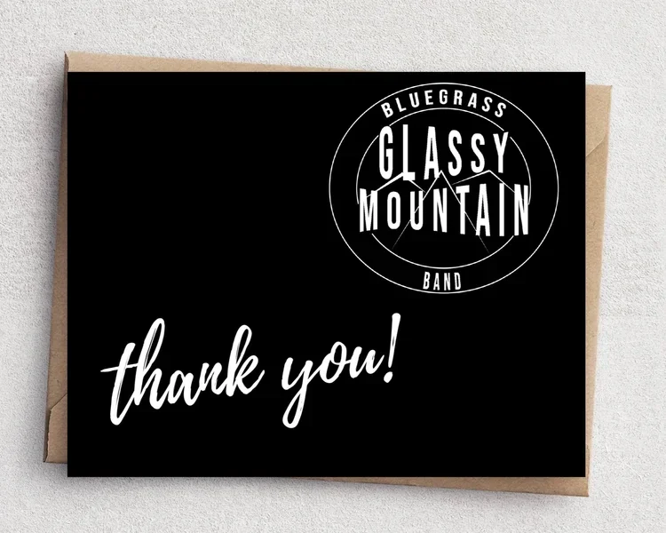 A black thank you card with the Bluegrass Glassy Mountain Band logo in white, and the words "thank you!" written in cursive.