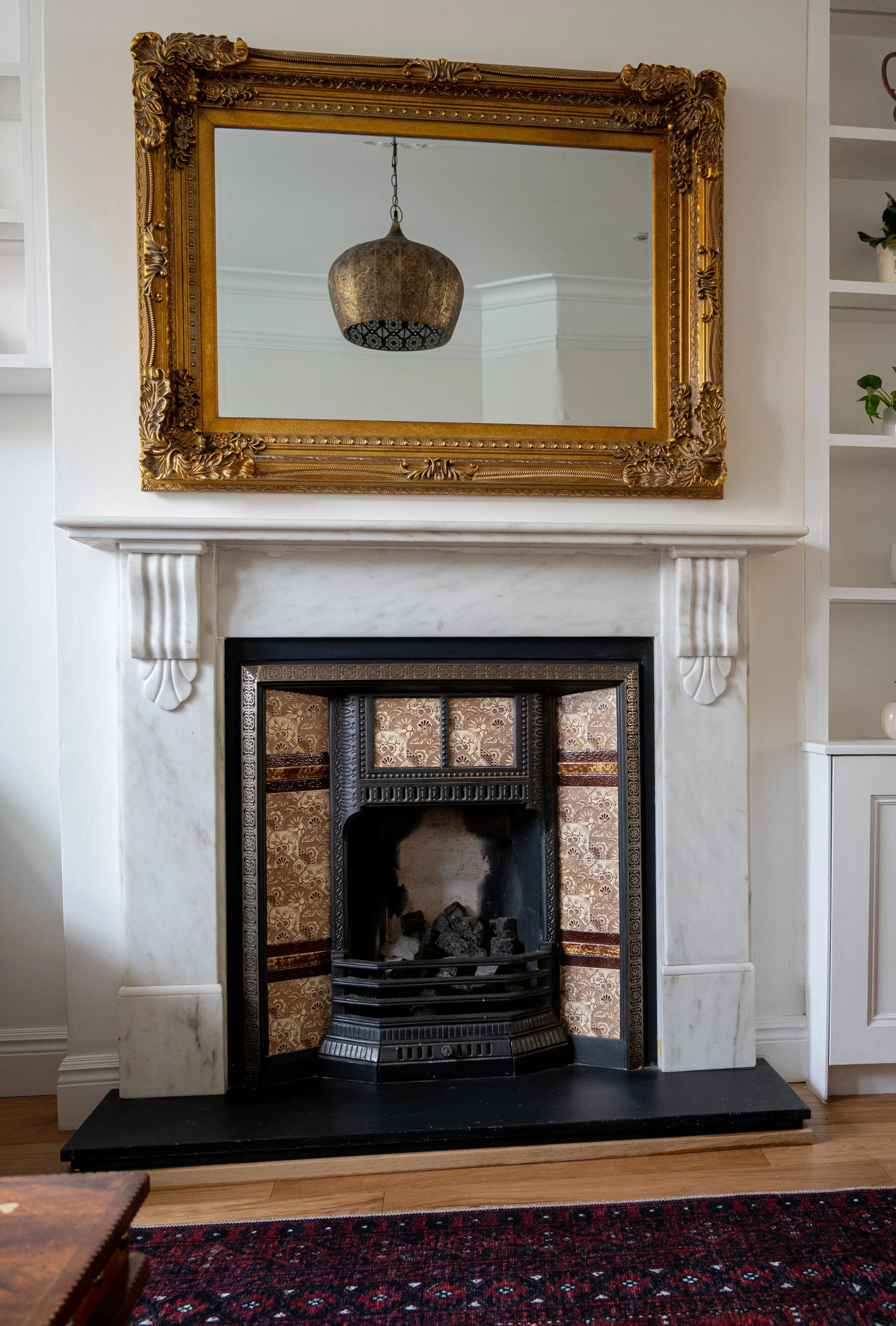 Victorian fireplace with brass mantel mirror