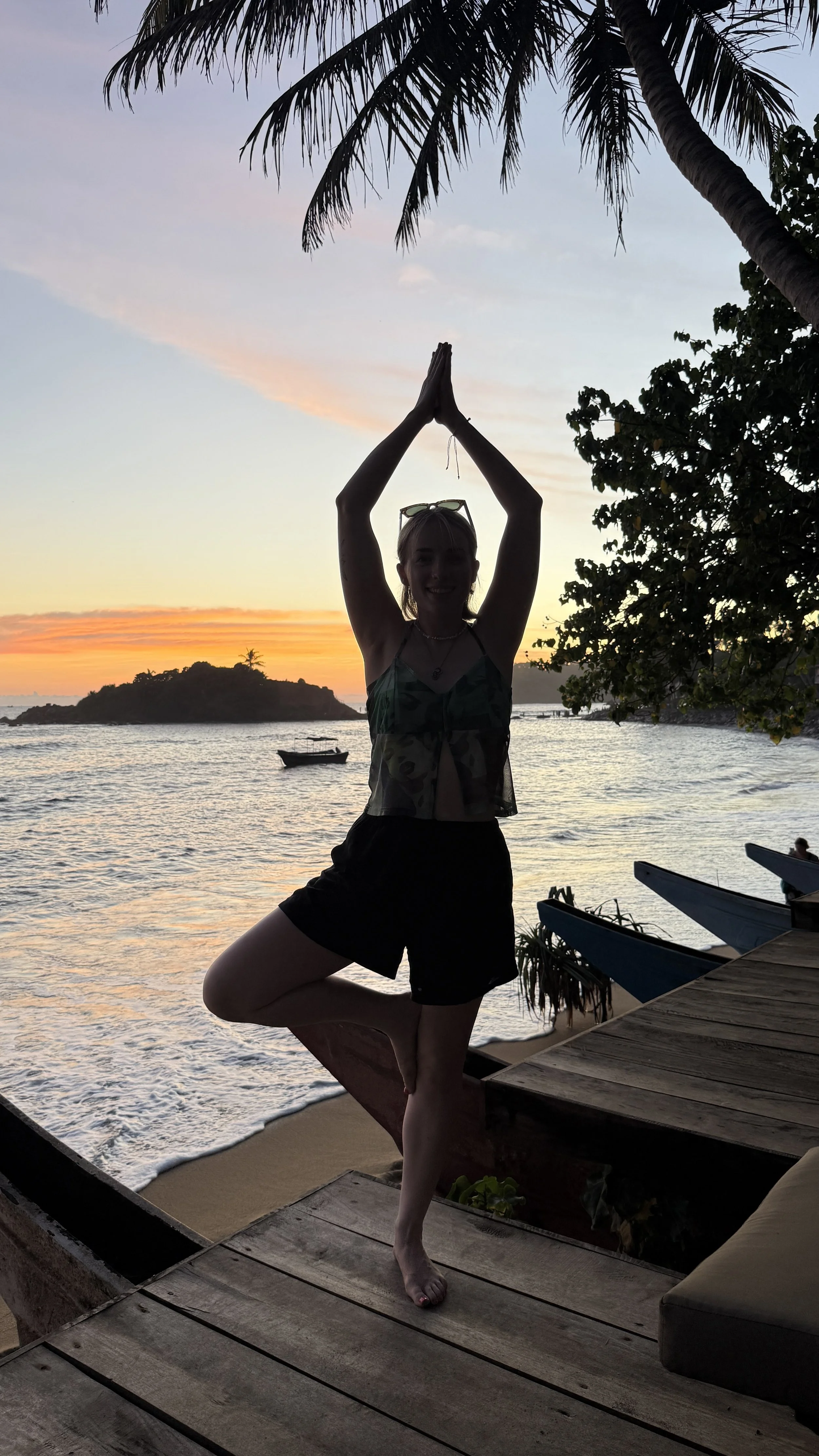 Reiki practitioner Gabrielle Spooner practising yoga at sunset
