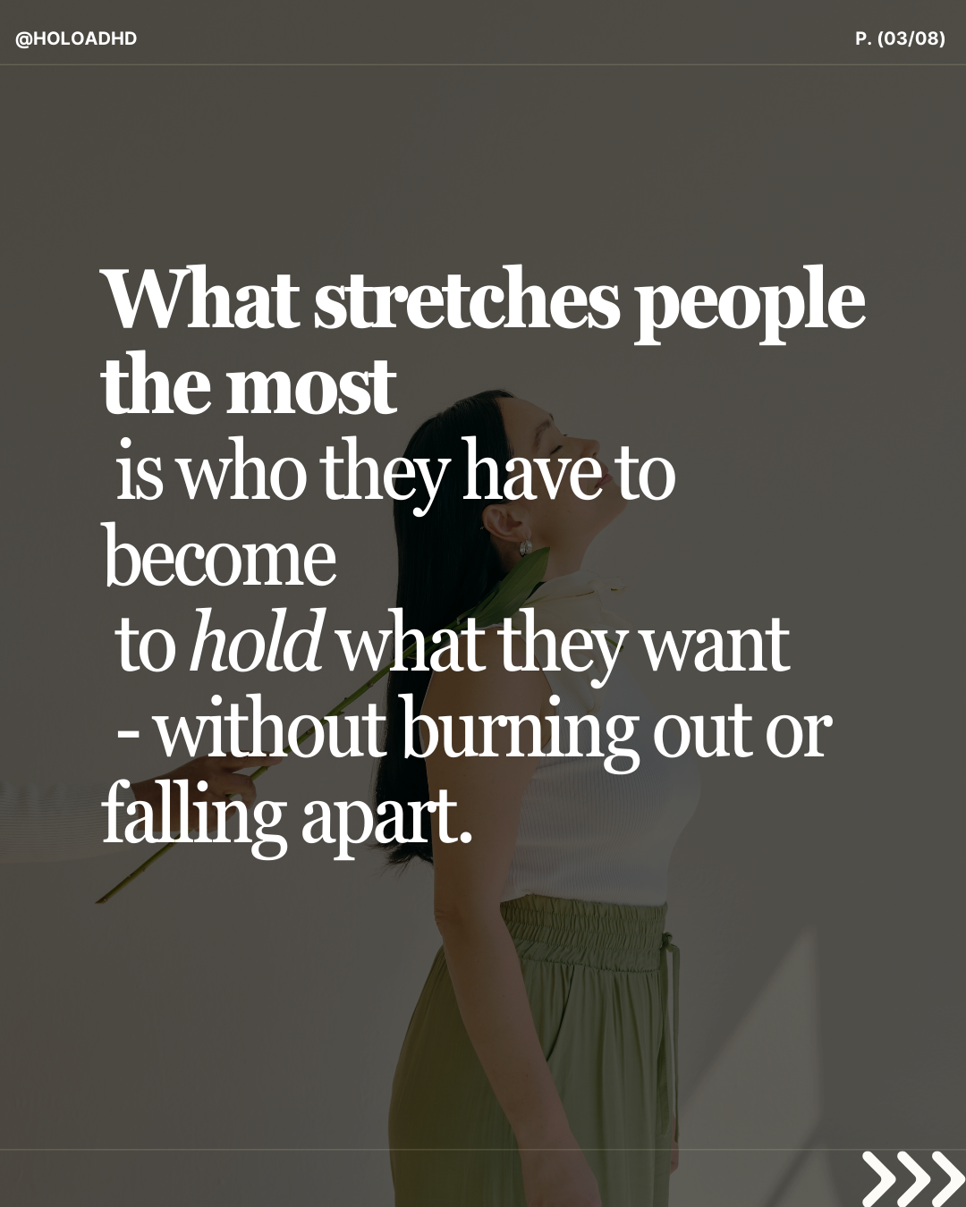 Woman in a white top holding a flower behind her back with eyes closed and smiling.