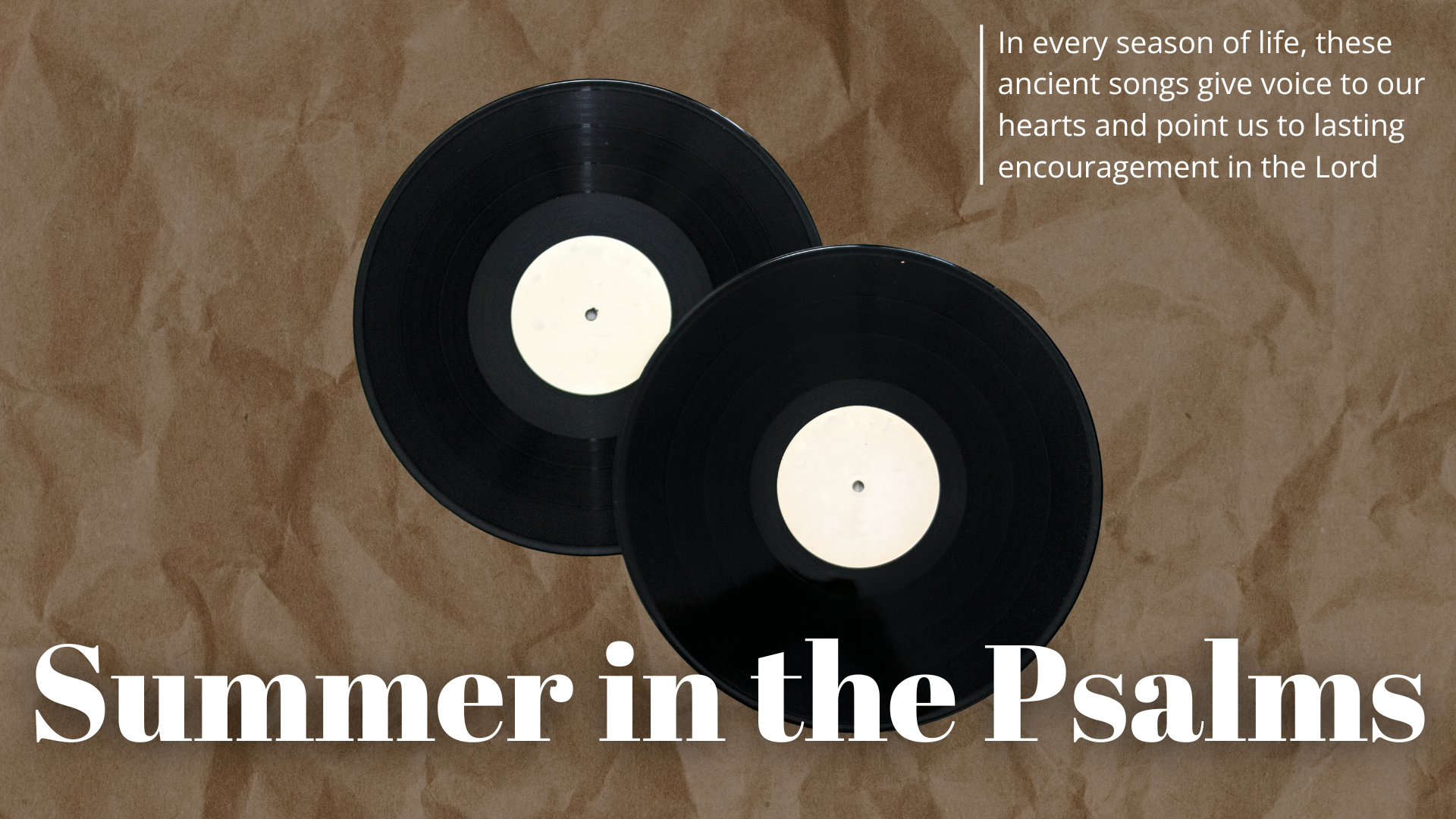 Two black vinyl records with white labels placed on a brown textured surface.
