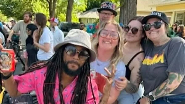 Group of friends enjoying an outdoor gathering, smiling and posing for a photo.