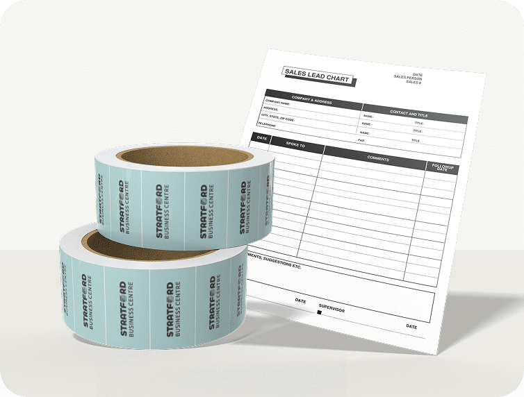Two rolls of custom sticker tape and a mock certificate on a white surface.