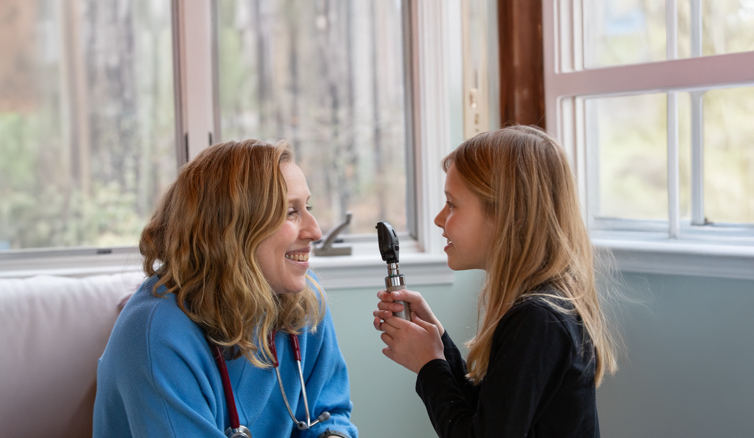 Dr. Alla Goldburt smiling at a child
