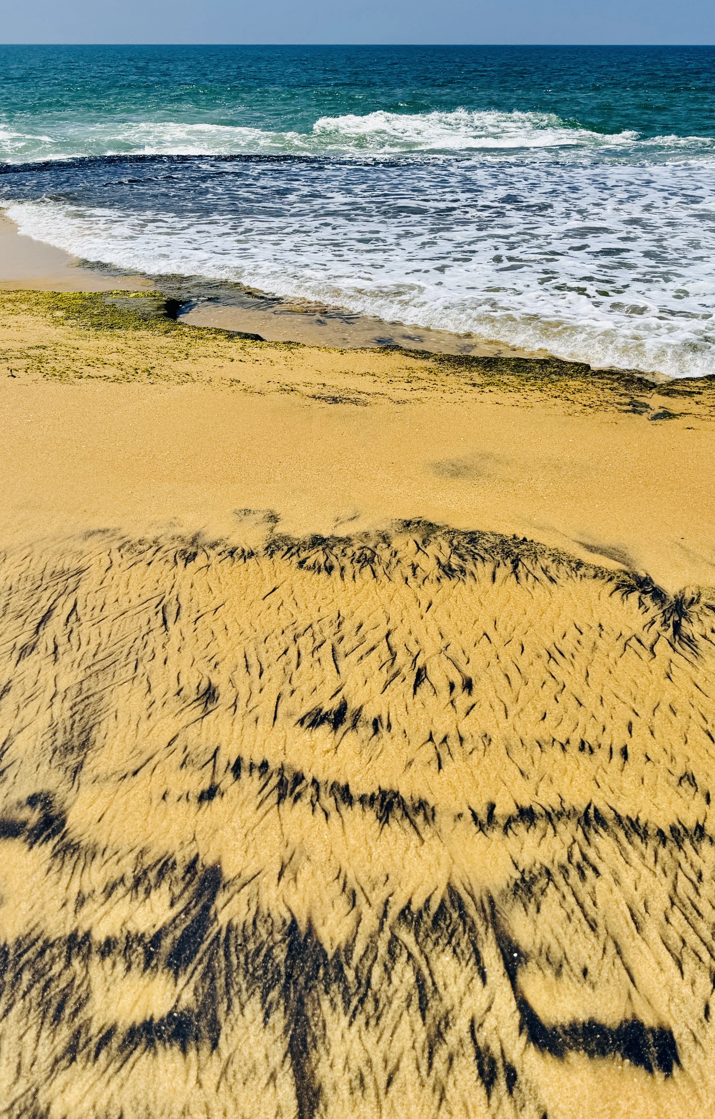 The colours in the sand and the crash of the waves.