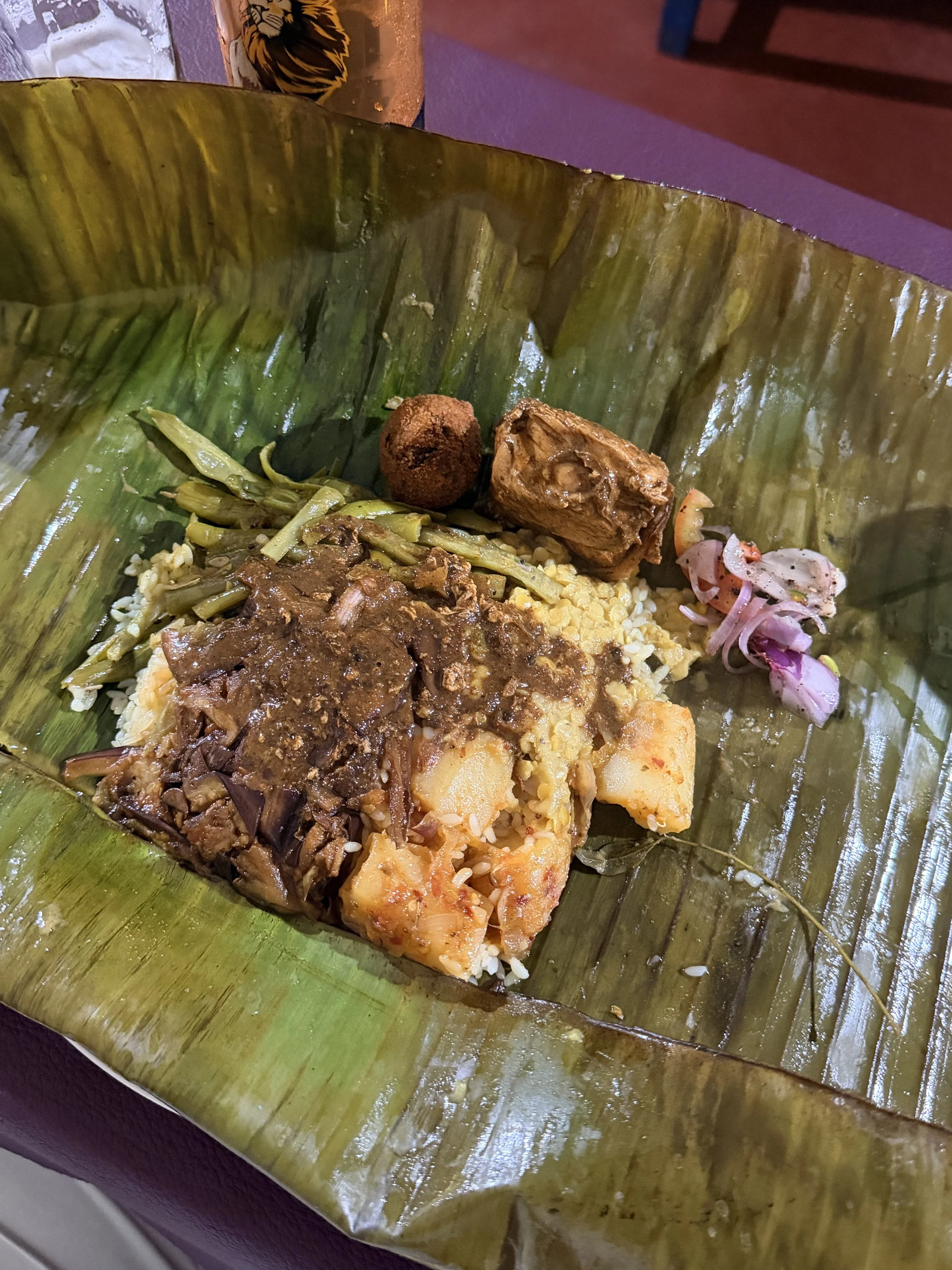 Lamprais.  Introduced by the Dutch in the 18th century - savoury rice and mixed meat, seeni sambol (onion relish) and ash plantain curry, wrapped in banana leaves and baked.