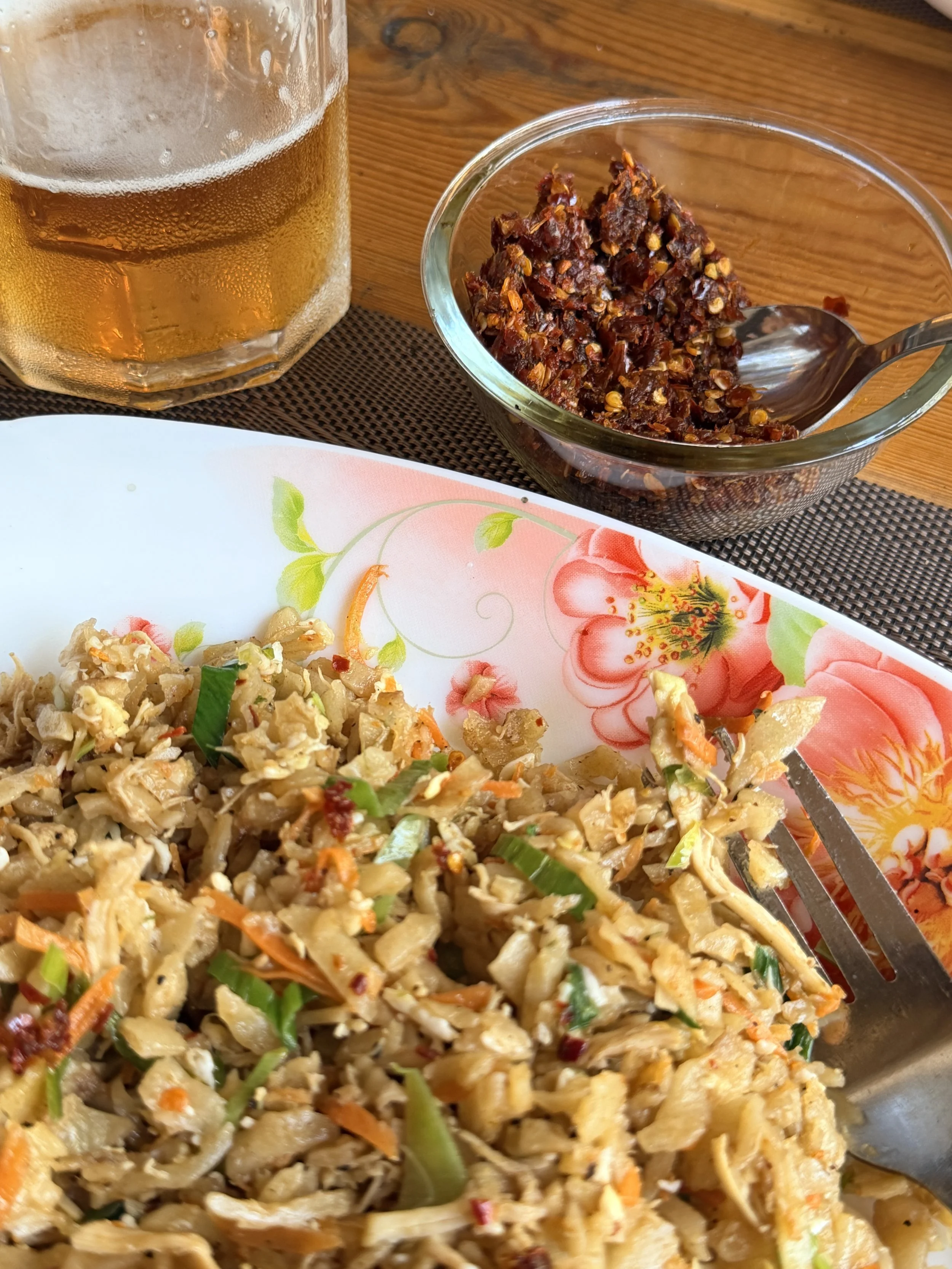 Kottu!! With chilis and a beer.  Kottu - a thick parantha (roti) that's chopped up and fried with eggs, veggies, chicken, chilis and any number of things.  Absolutely delicious.