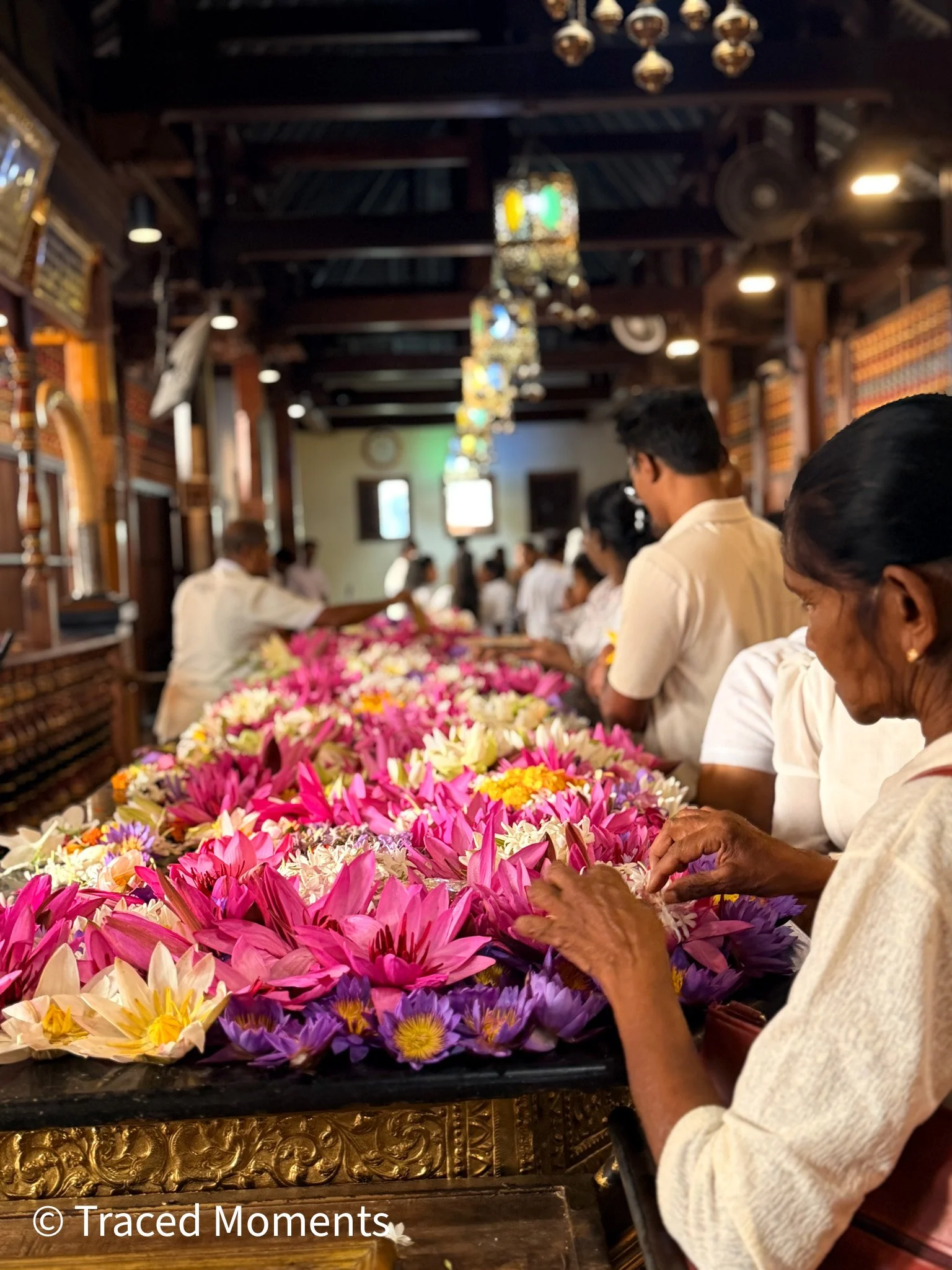 At the temple in Kandy, visitors make a donation of flowers to worship the Buddha.