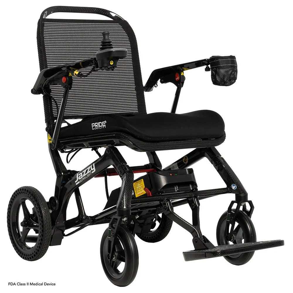 A black and gray electric wheelchair with a mesh backrest, a cushioned seat, small front and large rear wheels, and a joystick controller on the armrest.