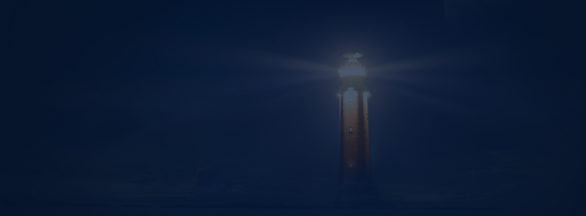 A lighthouse shining bright light into the night sky.