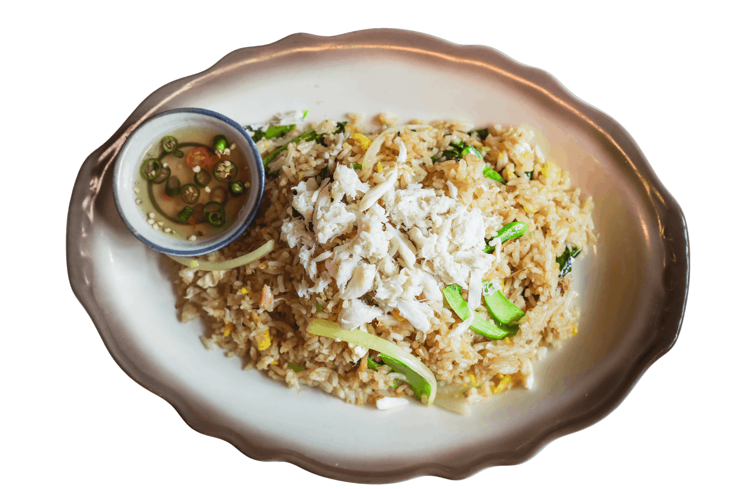 Crab Fried Rice on a scalloped plate, topped with generous flakes of white crab meat and scallions, served with a small bowl of chili fish sauce.