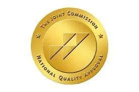 Gold medal with the text 'The Joint Commission National Quality Approval' and a stylized 'J' in the center.