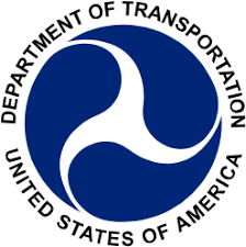 Department of Transportation emblem featuring a stylized white wave on a blue background, surrounded by the text 'DEPARTMENT OF TRANSPORTATION' and 'UNITED STATES OF AMERICA'.