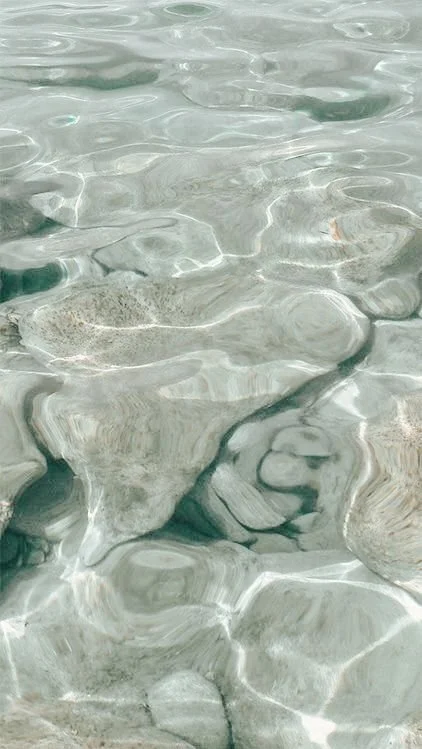 Clear water with smooth stones visible beneath the surface.