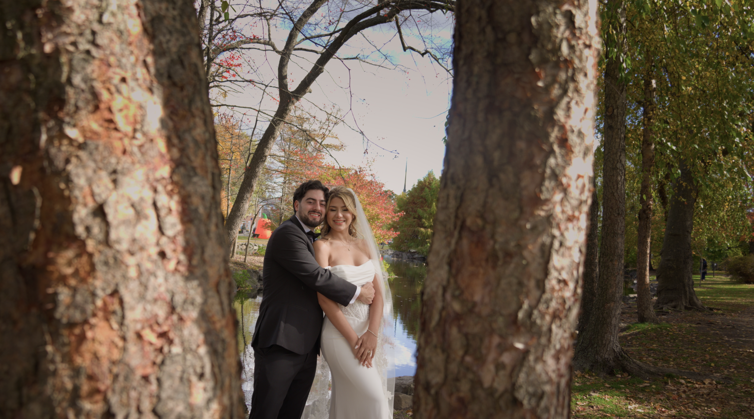 Two couples hugging and celebrating at a wedding venue and park to celebrate the wedding in a film