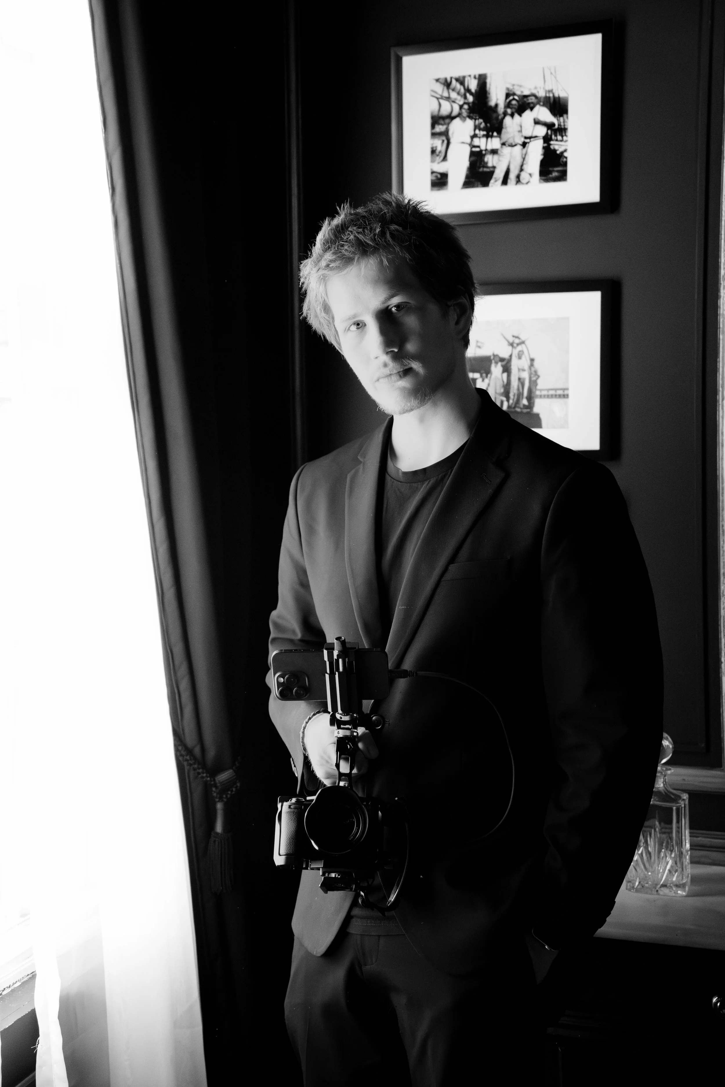 Filmmaker black and white posing with a professional camera