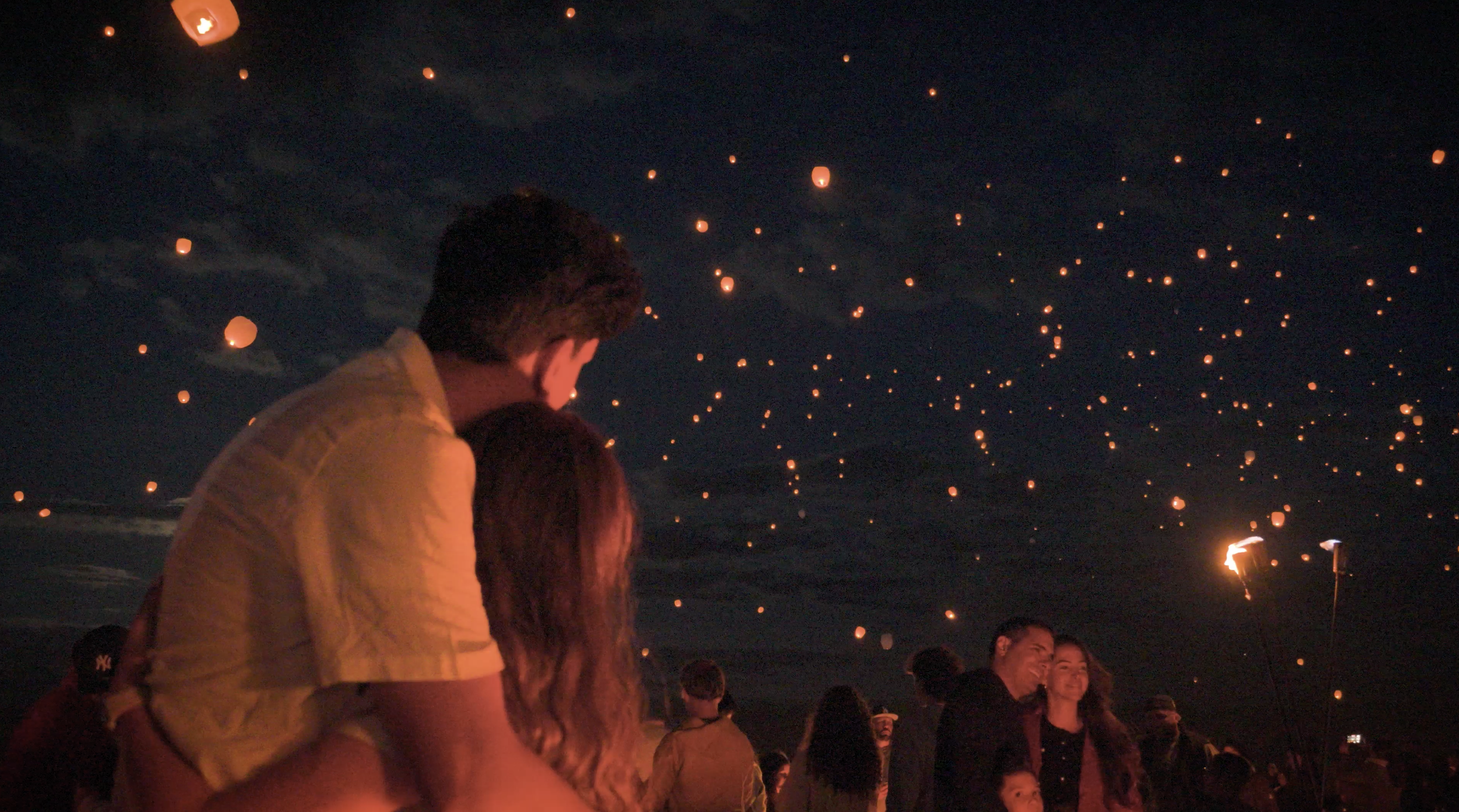 Two couples hugging and celebrating at a wedding reception/venue 