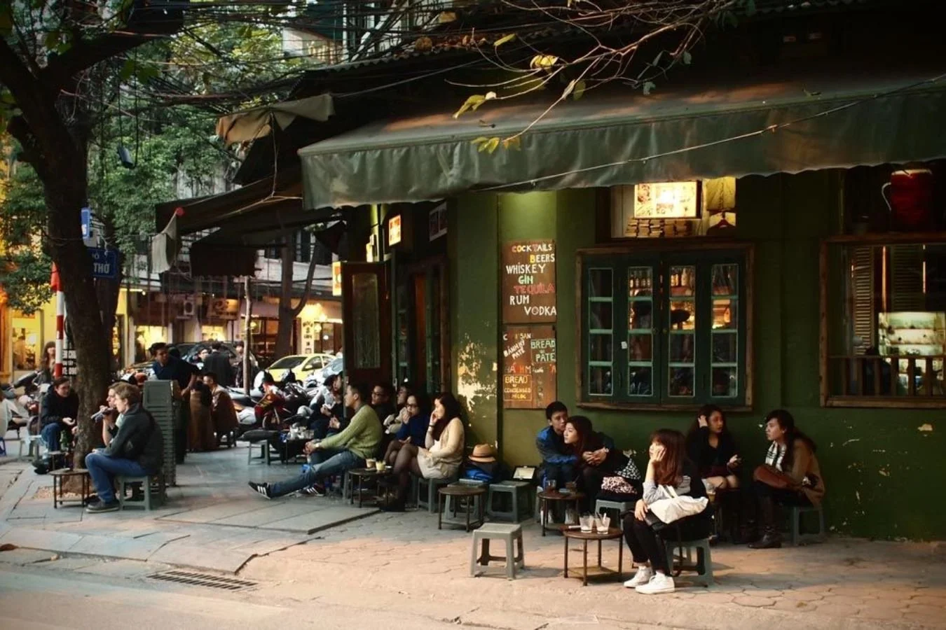 People sitting outside a streetside cafe in Vietnam