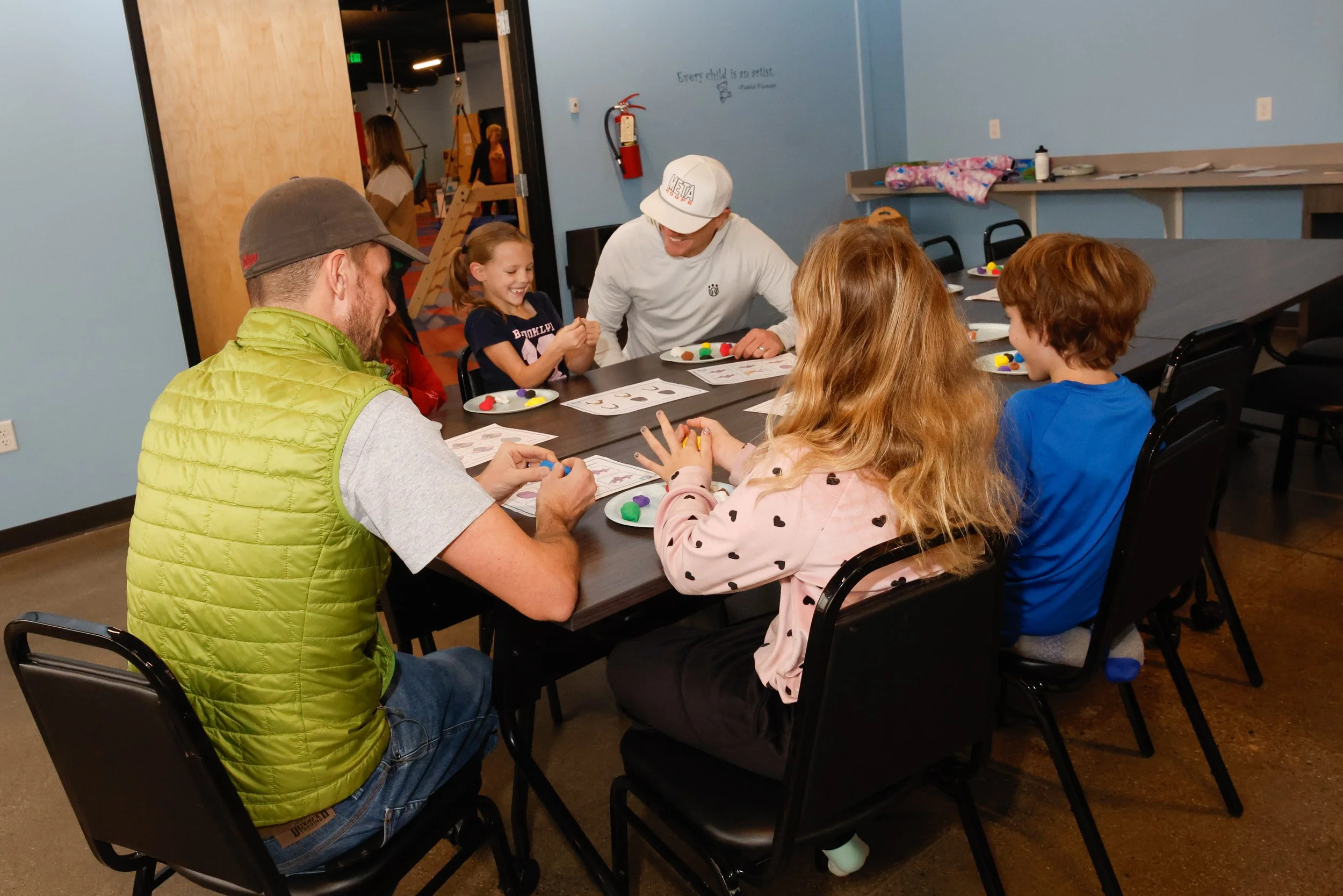 Parents and kids working together in art class.