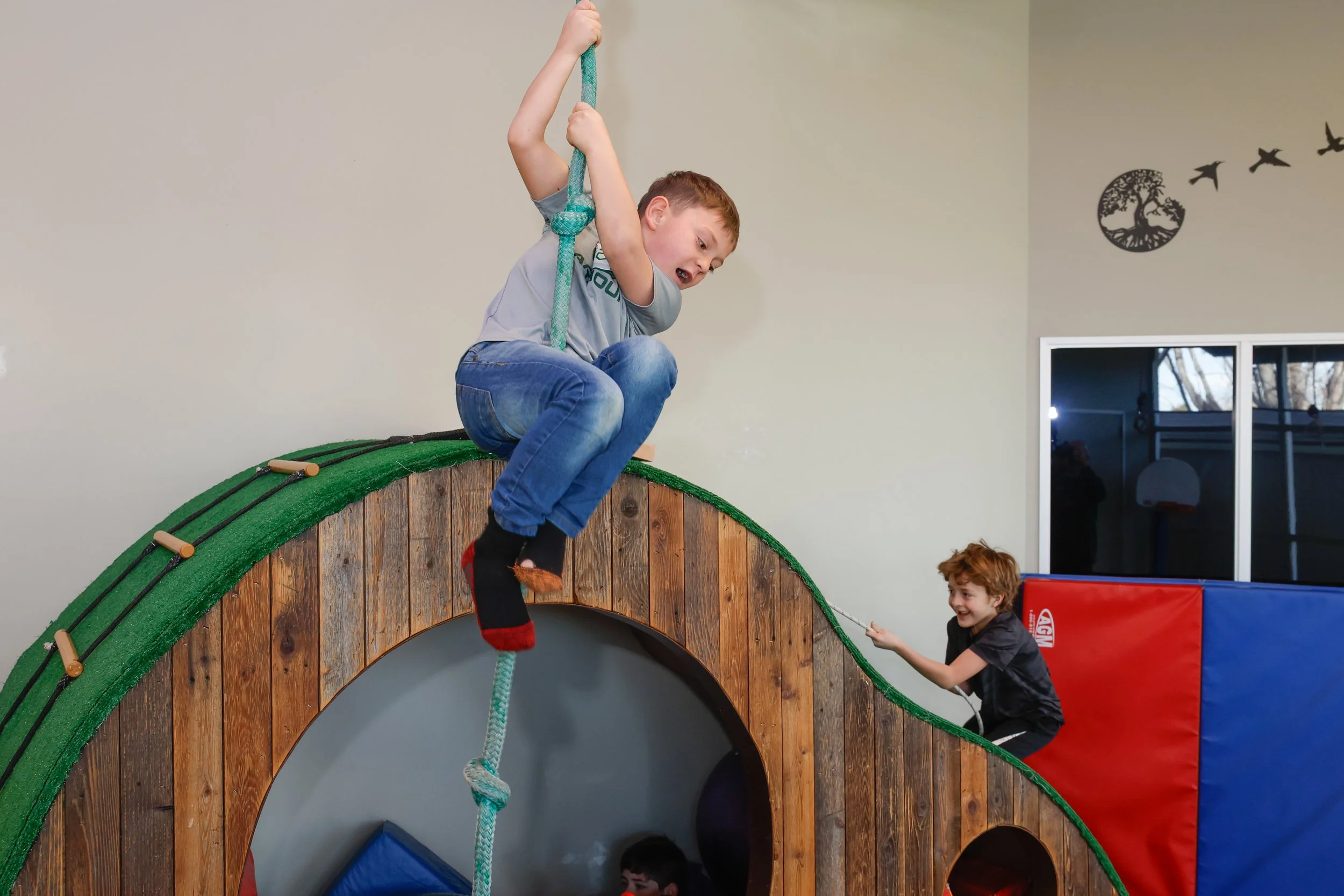 Kids climbing on a jungle gym at summer camp in Boise.