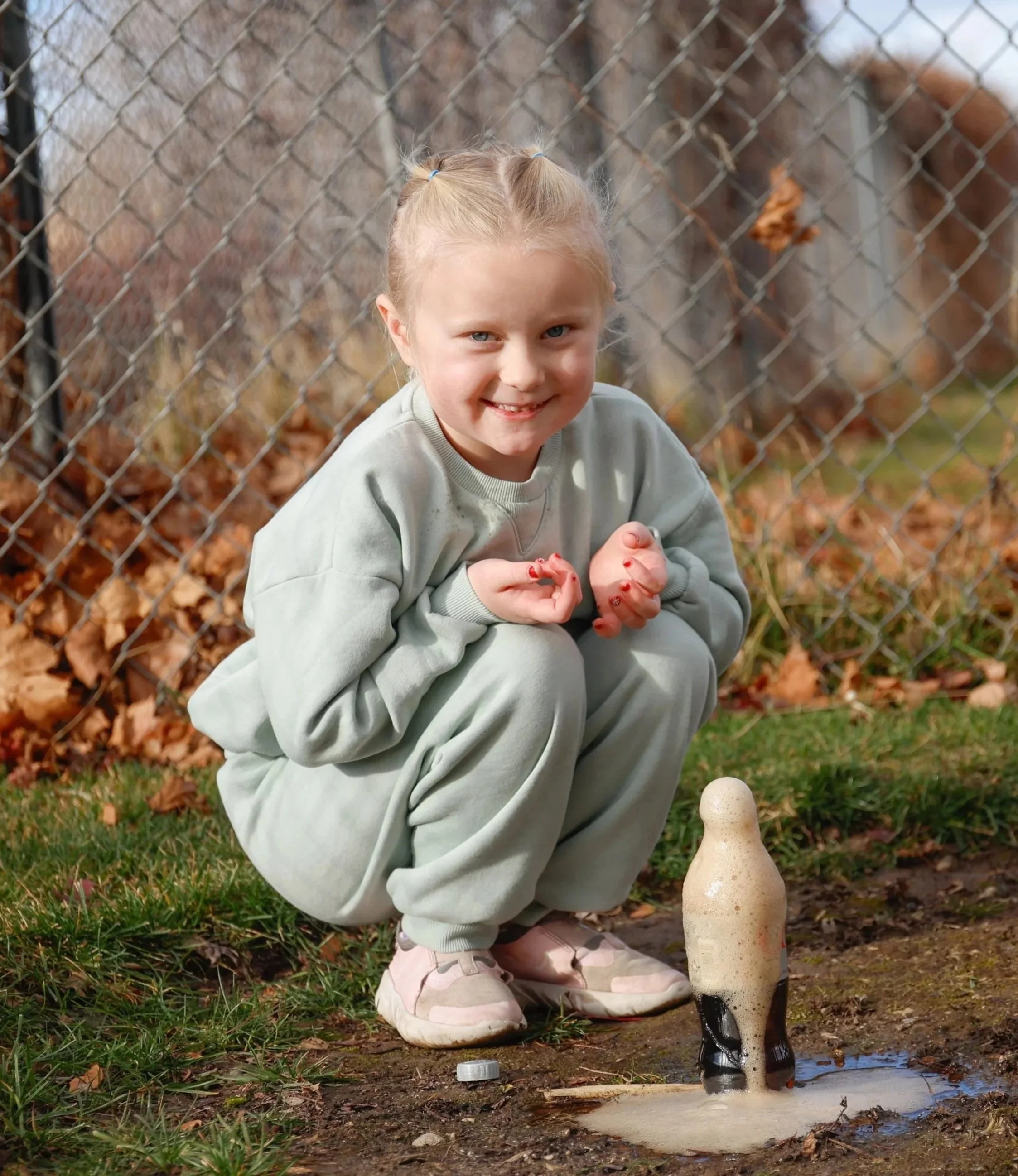 A kid doing a STEM activity in science class outdoors.