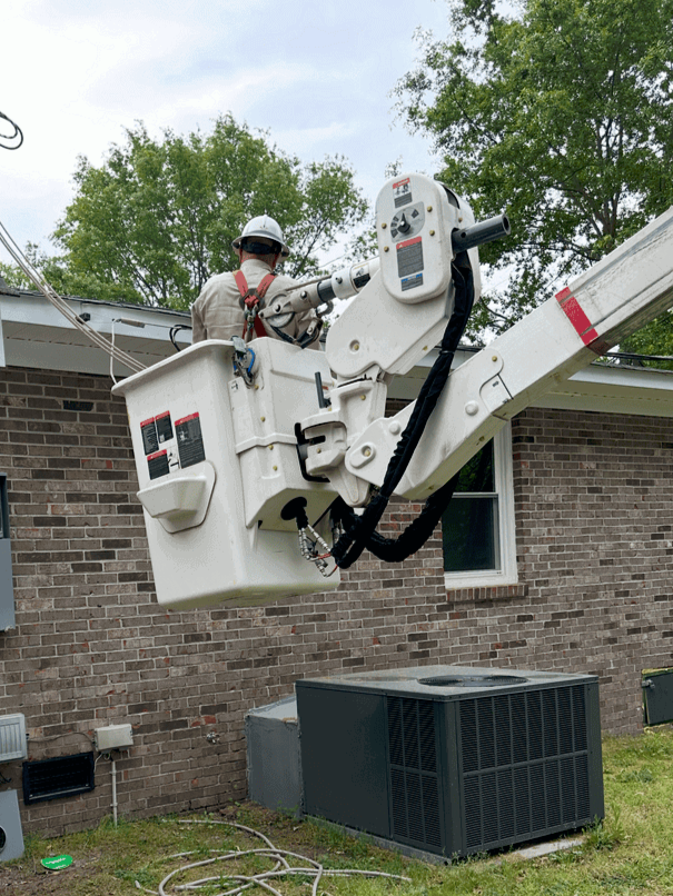 electrician on a lift rewiring a house