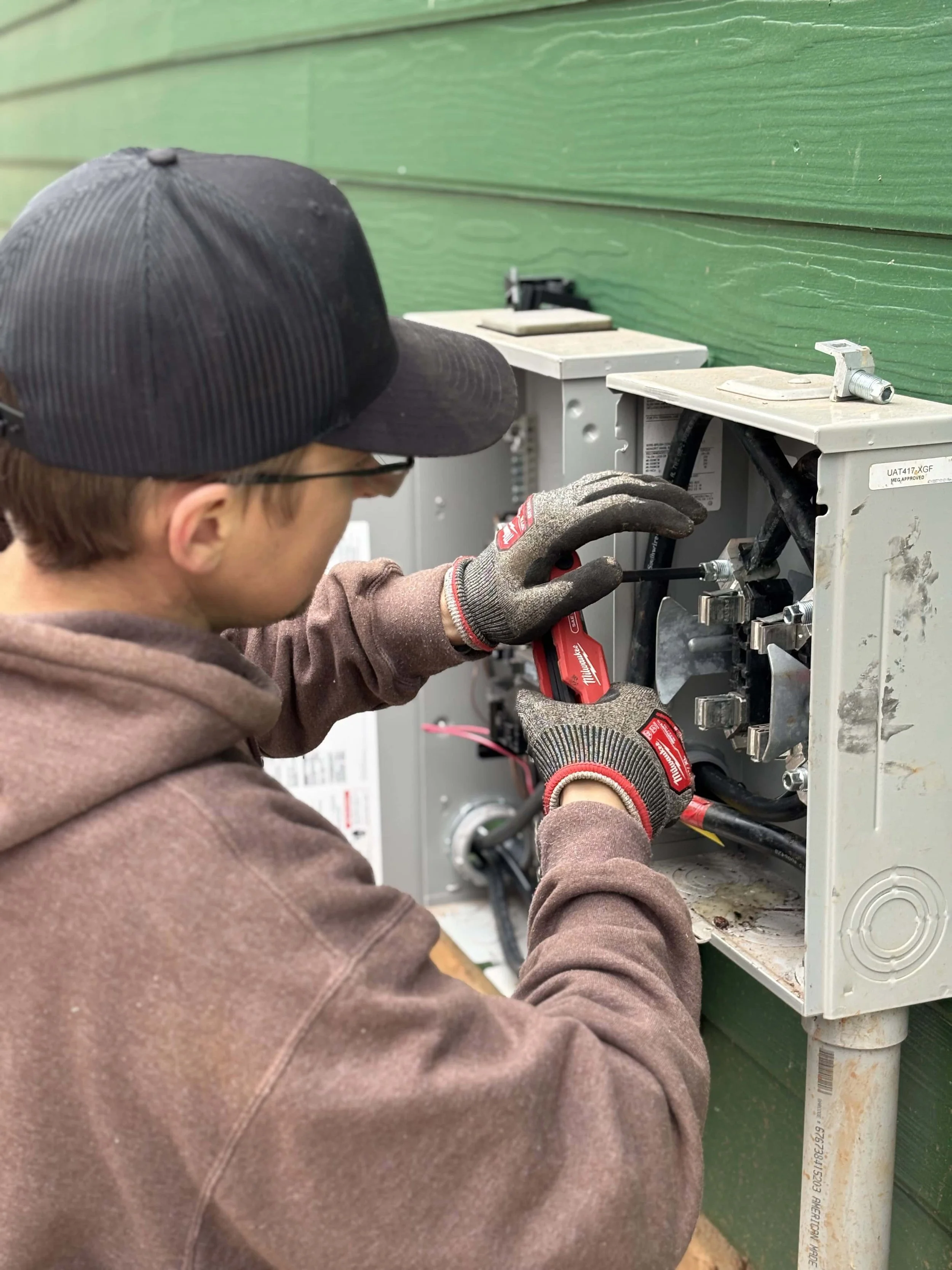 electrician wiring in a generator to the breaker panel