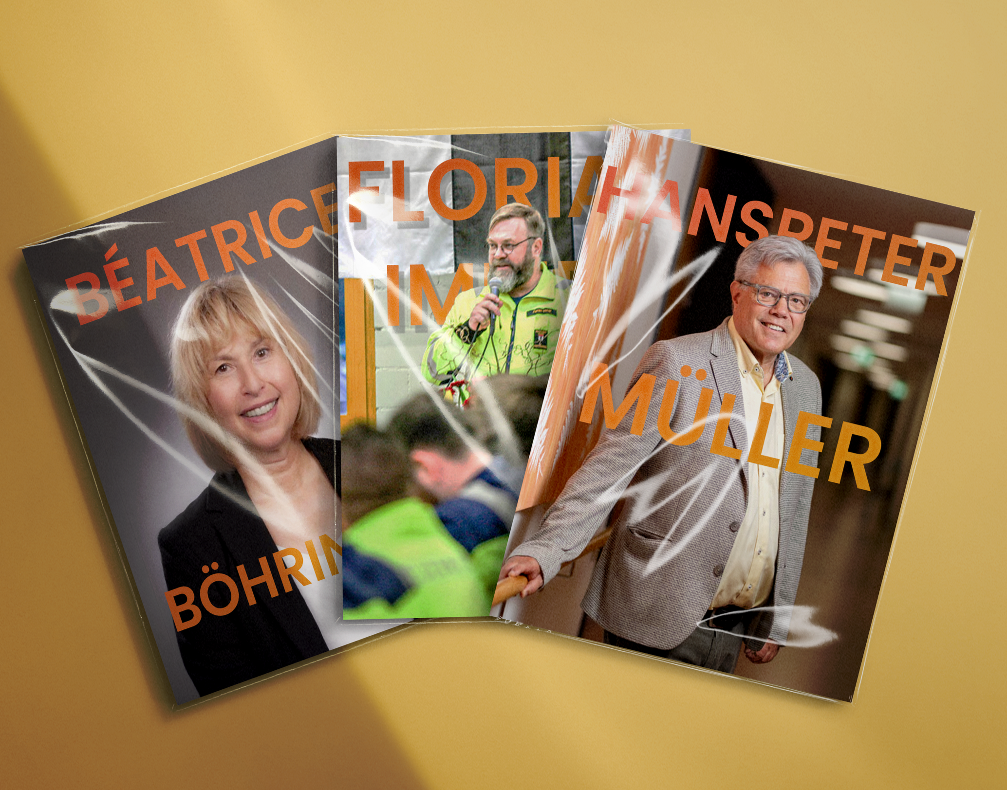 Mehrere Magazine mit Porträts und Titeln in deutscher Sprache liegen auf einem Tisch, darunter ein Artikel mit einem Mann in Anzug und Brille, der lächelnd in die Kamera schaut, und ein anderer mit einem Mann, der bei einer Veranstaltung spricht.