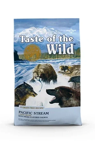 Bag of Taste of the Wild Pacific Stream dog food with illustrations of mountains, river, and various wild animals including bears, wolves, and salmon.