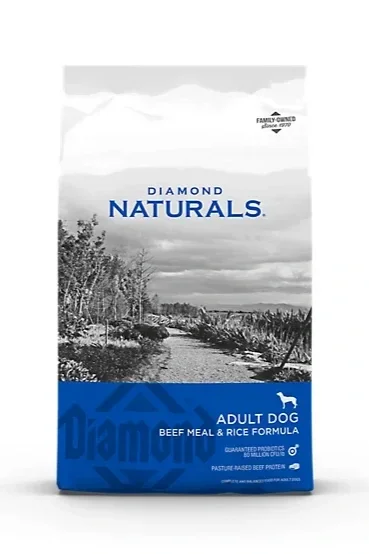 Package of Diamond Naturals adult dog food with beef meal and rice formula, featuring a landscape with trees and sky.