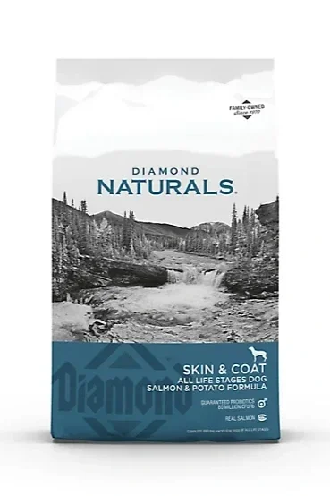 Bag of Diamond Naturals Skin & Coat dog food with a mountain landscape design, indicating it is suitable for all life stages and contains salmon and potato formula.