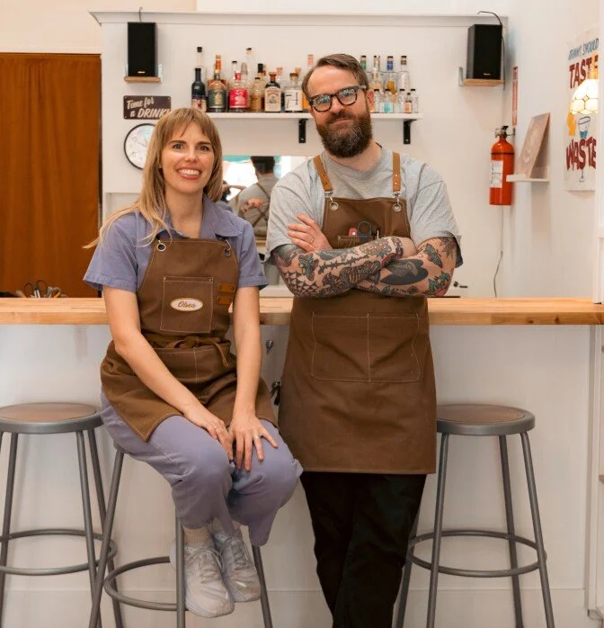 Burden of Proof founders Obreanna and Dean stand in front of their tasting bar within their non-alcoholic beverage store in South Pasadena, California