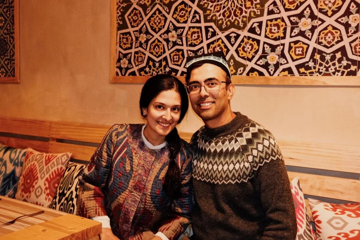 Azim Rahmatov chef and founder of Zira Ubek Kitchen sitting inside the restaurant that has beautiful interiors honoring his culture.