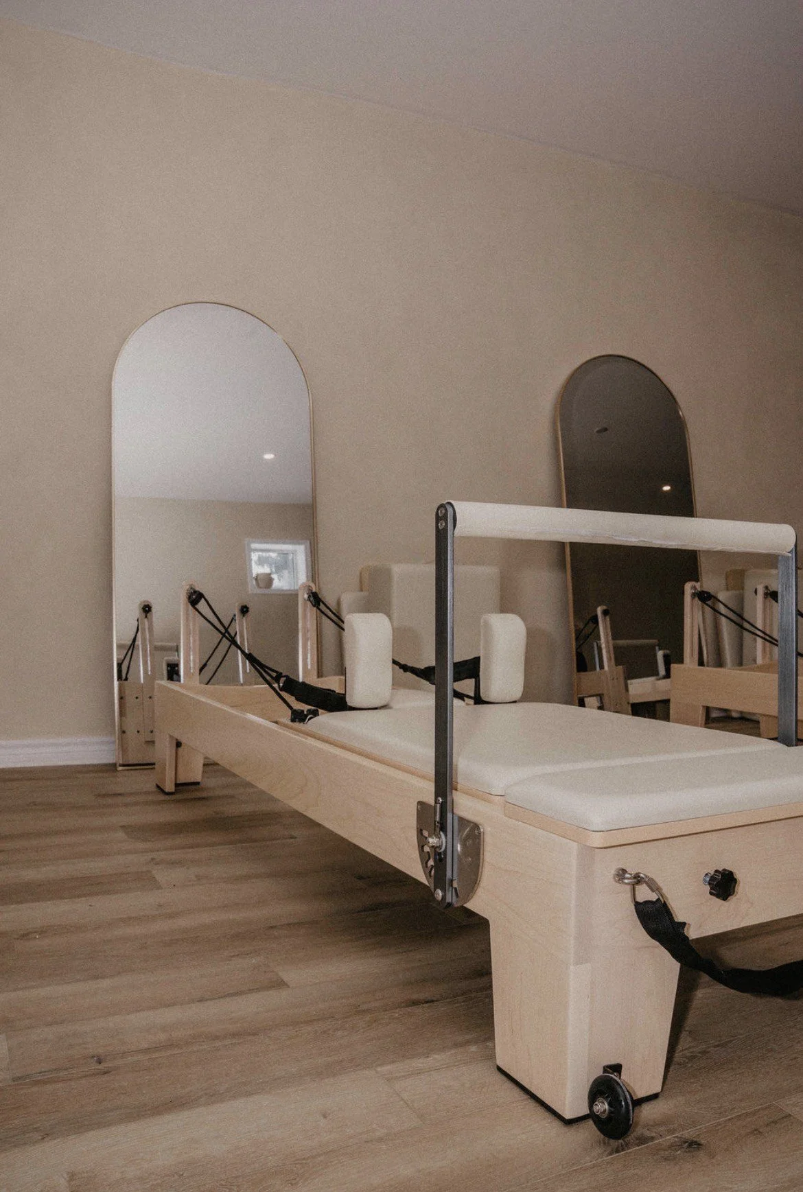 A physical therapy or rehabilitation bed with adjustable features, side supports, and two mirrors in a therapy room.