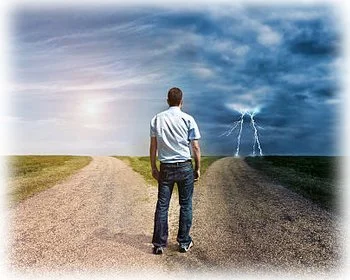 A man stands at a fork in the road deciding which path to choose.