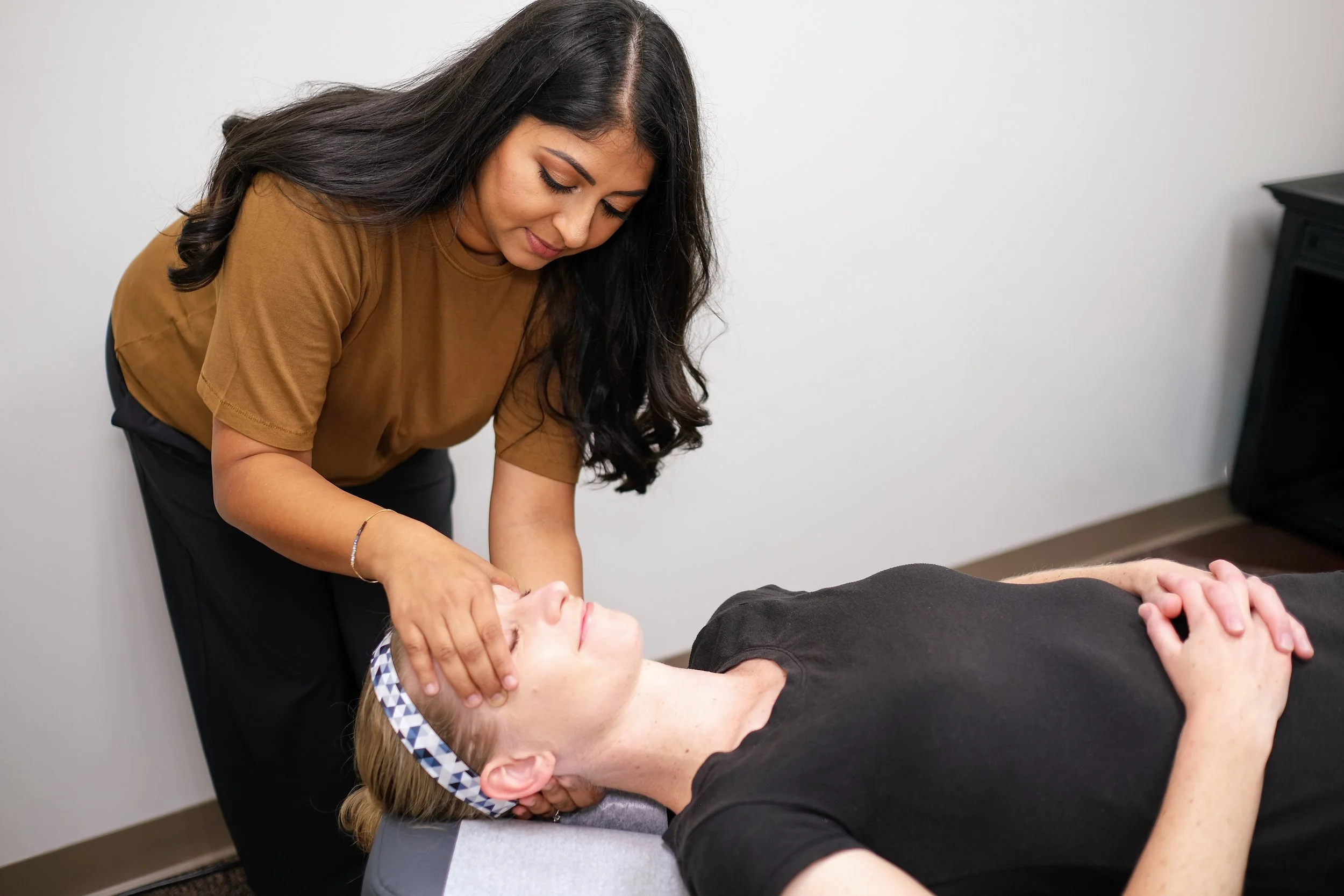 Dr. Shivani Patel performing gentle craniopathy (cranial work) on a patient at Shakti Chiropractic, serving Franklin and Brentwood, TN