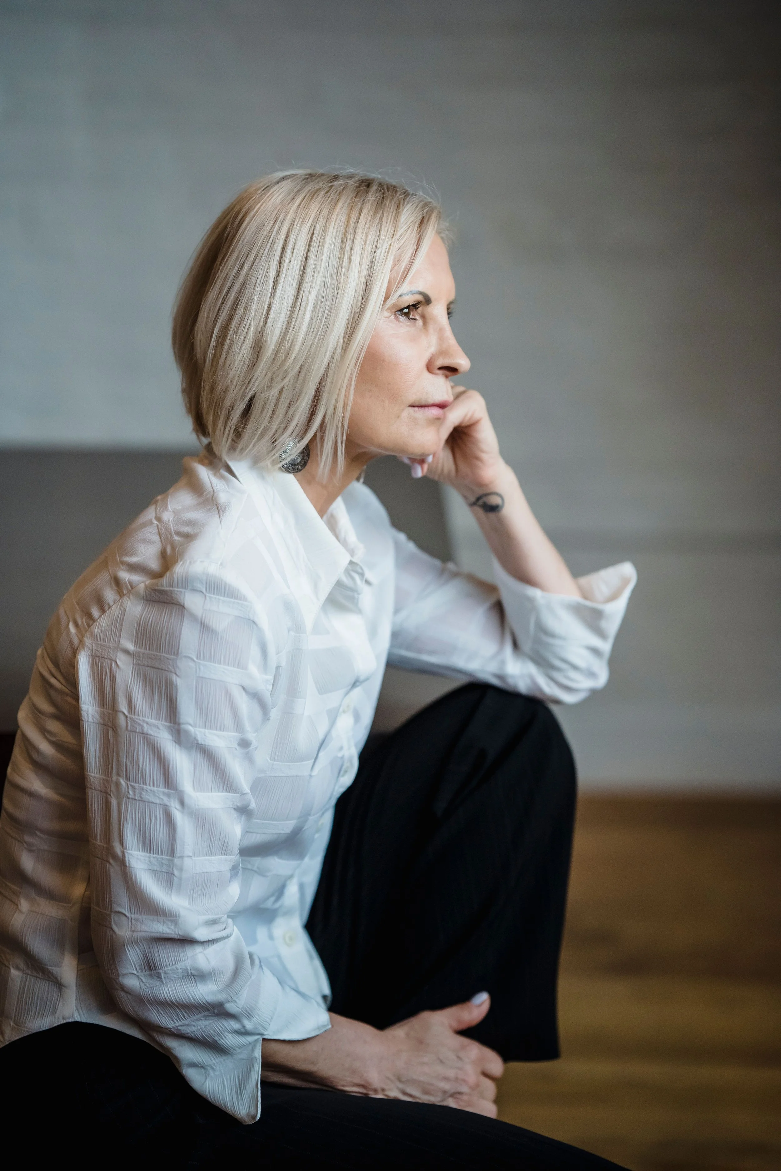 midlife woman looking thoughtful