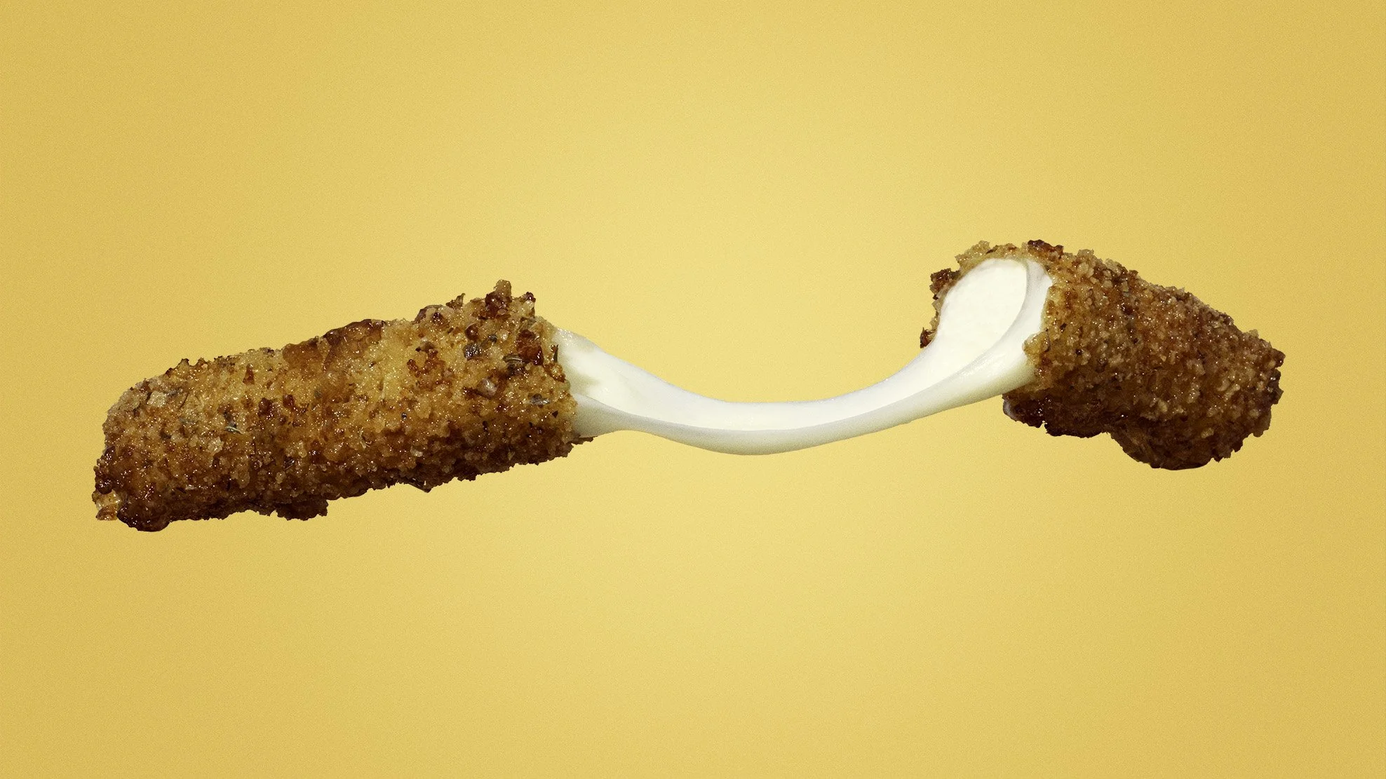 Mozzarella stick cheese pull on a yellow background.