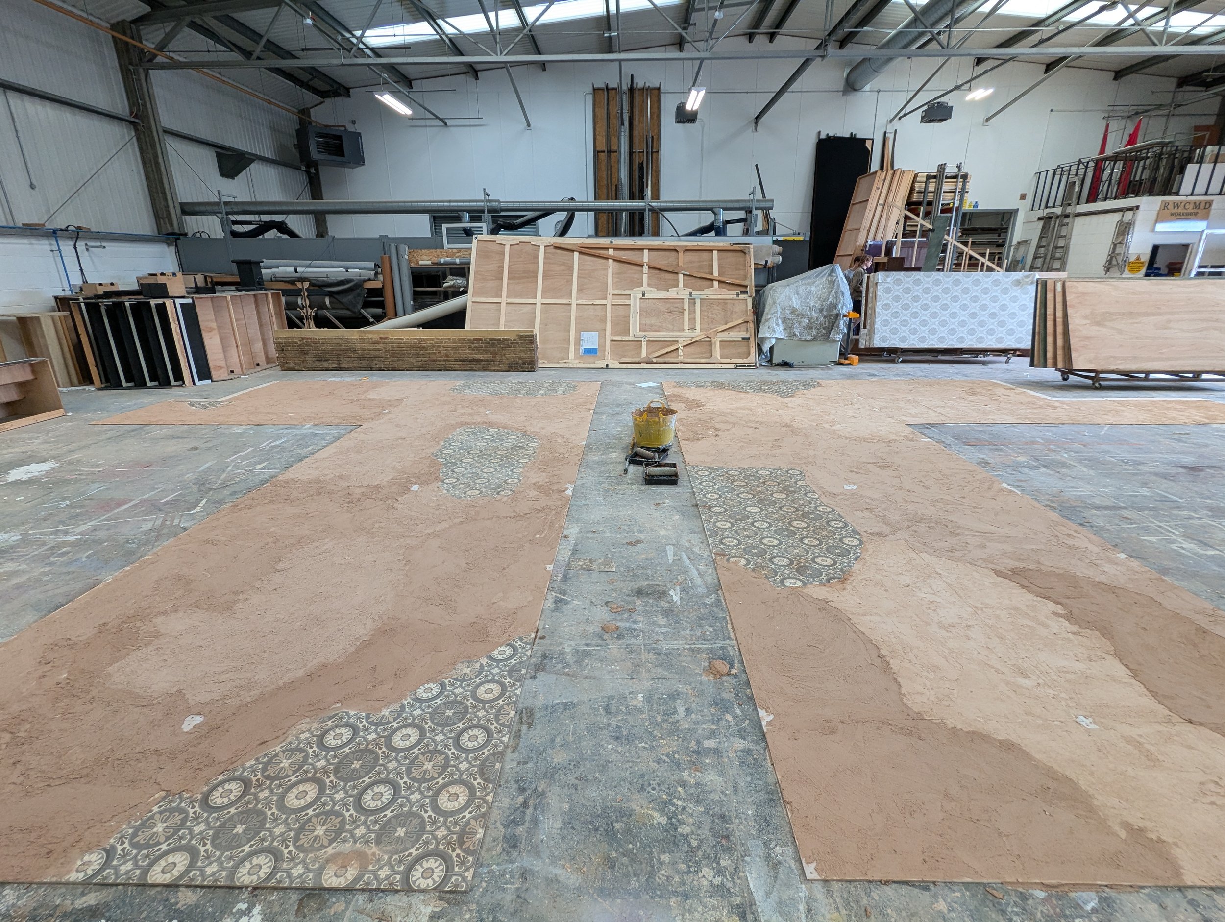 Plastering the stone floor and laying tiled vinyl